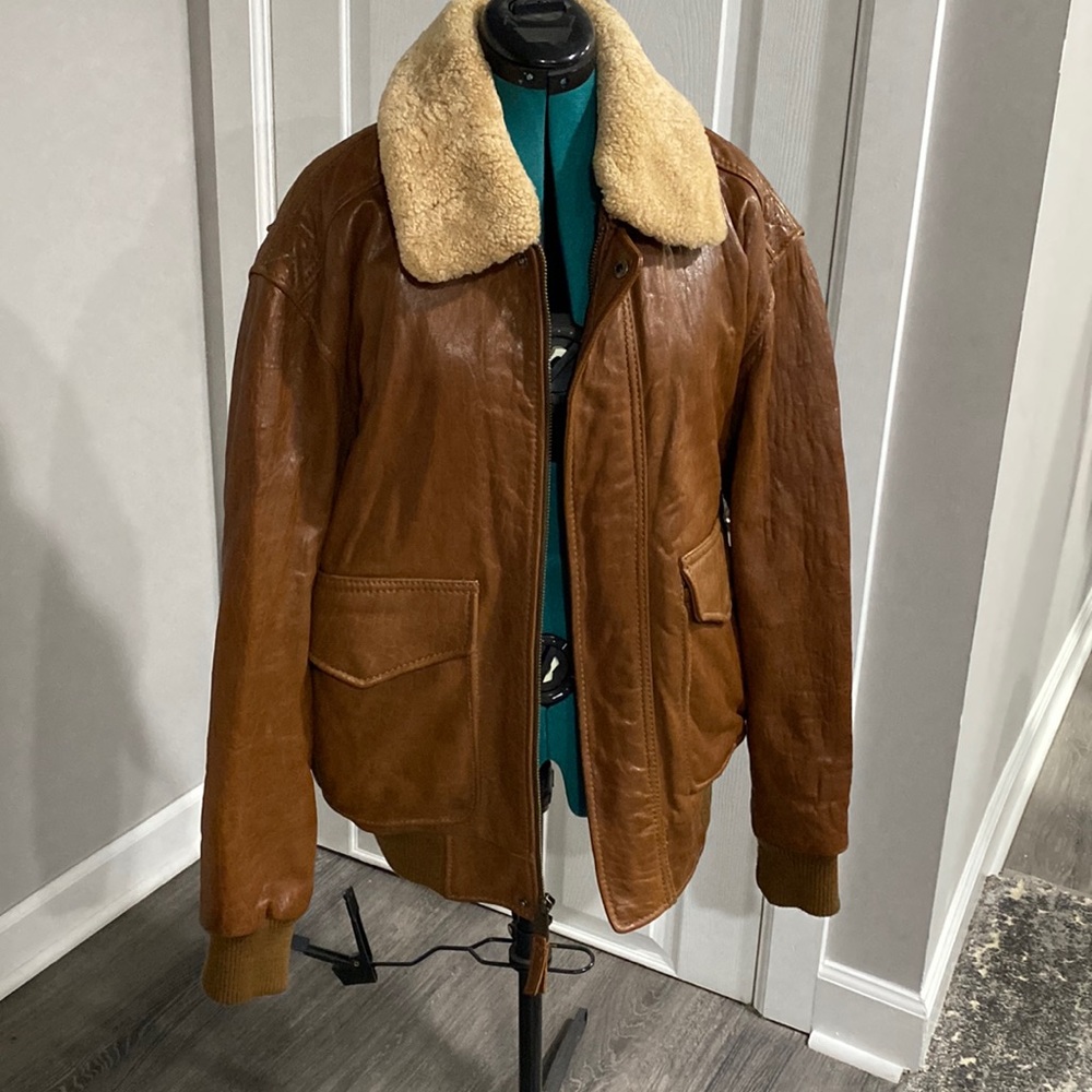 Tan brown heavy leather coat with detachable collar.